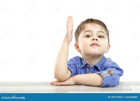 Little Boy Of Preschool Age Raises His Hand To Answer The Question Or