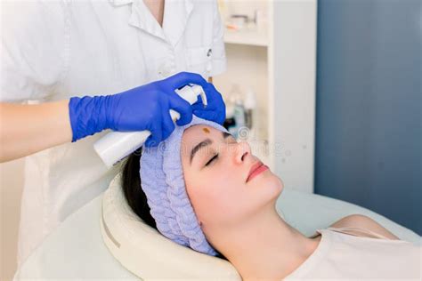 Beautiful Face Skin Cosmetologist Doing Beauty Procedure For Patient Face Massage Skincare