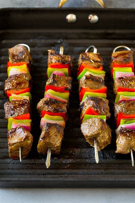 Several Skewers Of Meat And Vegetables On A Grill