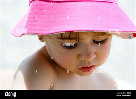 Close Up Potrait Of Adorable Little Girl Outdoors Wearing Sun Hat Stock