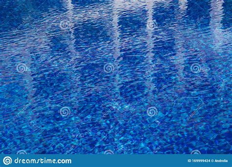 Abstract Background Of Blue Water Surface In Swimming Pool Stock Photo