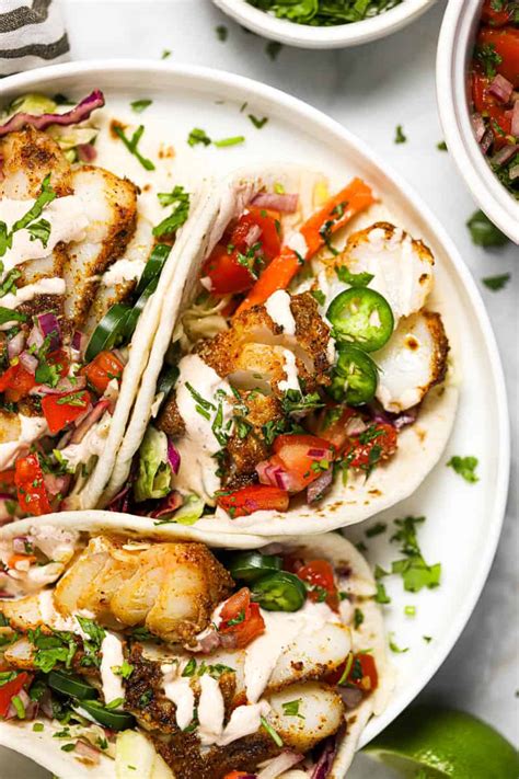 Oven baked fish tacos made with tilapia with creamy coleslaw and homemade peach salsa is an easy weeknight dinner recipe that is a seafood main dish your family will fall in love with. Baked Fish Tacos | Midwest Foodie