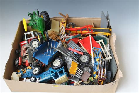 A Tray Of Playworn Britains Farm Toys Consisting Of Tractors And