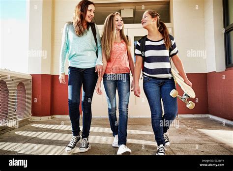 Teenage Girls Walking On School Campus Stock Photo Alamy