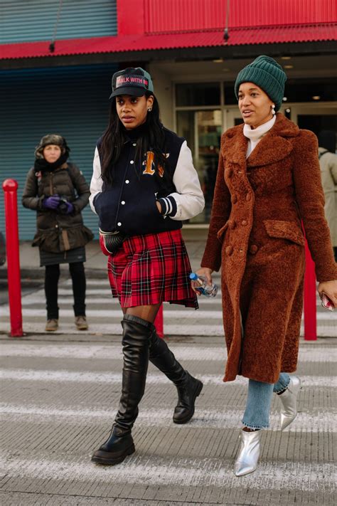 Showgoers Bundled Up In Belted Outerwear On Day Of New York Fashion