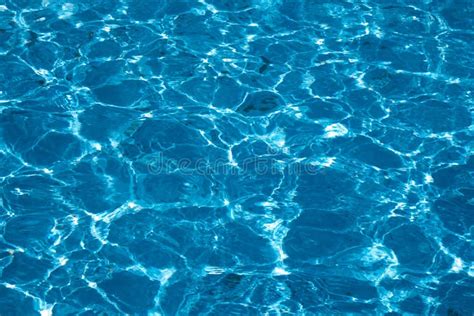 Blue And Bright Ripple Water Surface In Swimming Pool With Sun