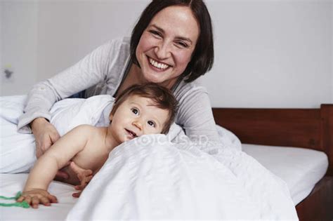 Mother And Baby Daughter Relaxing On Bed — Happiness People Stock