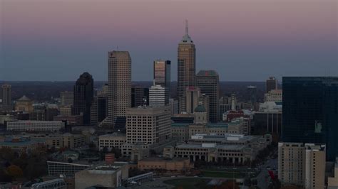 5.7K stock footage aerial video of a reverse view of the city's skyline at sunset in Downtown ...