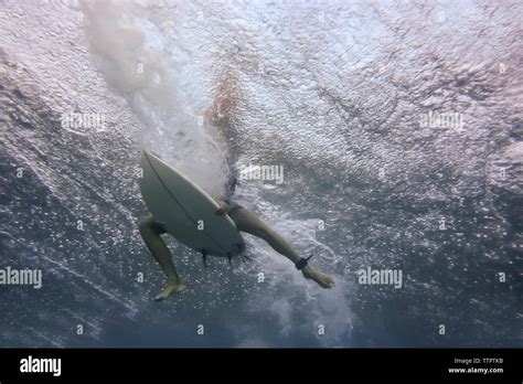 Low Section Of Man Surfing Undersea Stock Photo Alamy