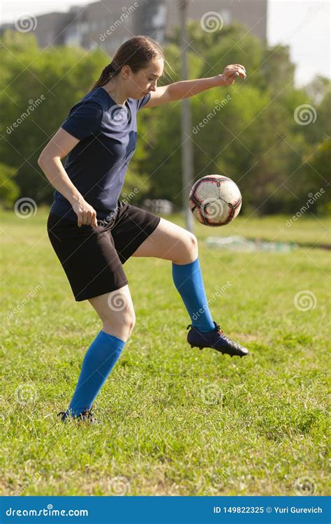 Young Football Player Kicking Ball On The Soccer Pitch Boy Wearing Red