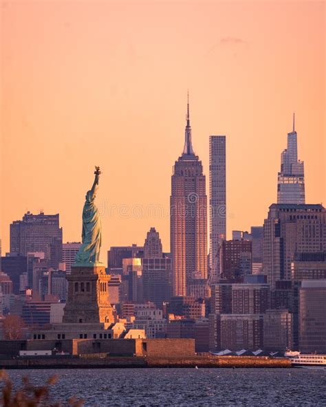 Vertical Early Morning View Of The Statue Of Liberty In The New York