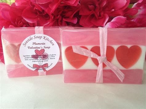 Two Soap Bars Wrapped In Pink And Red Paper With Hearts On Them