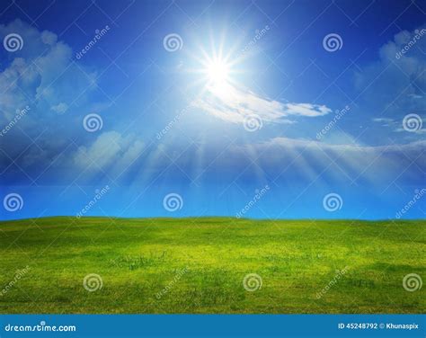 Beautiful Green Grass Field With Sun Shine On Clear Blue Sky Stock