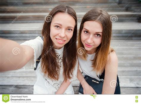 Portrait Of Caucasian Beautiful Girls Making Selfie Outdoors Young Tourist Friends Traveling On