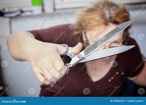 Older Woman Holding Scissors To The Camera Stock Image Image Of