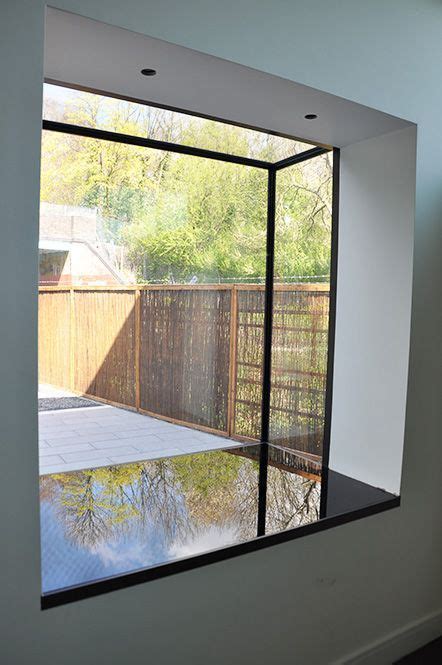 A Frameless Glass Window Seat With Black Back Painted Glass Base Bow Window House Windows