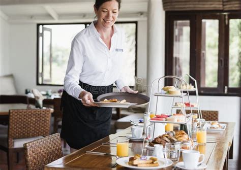 Hotel Waitress Serving Food On The Table Stock Photo Image Of