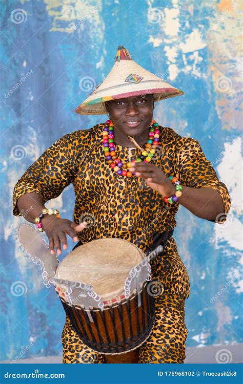 Handsome African Drummer Weared In Traditional Costume Playing On