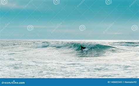 Turquoise Low Angle View Of Man Surfing On Sea Editorial Stock Photo