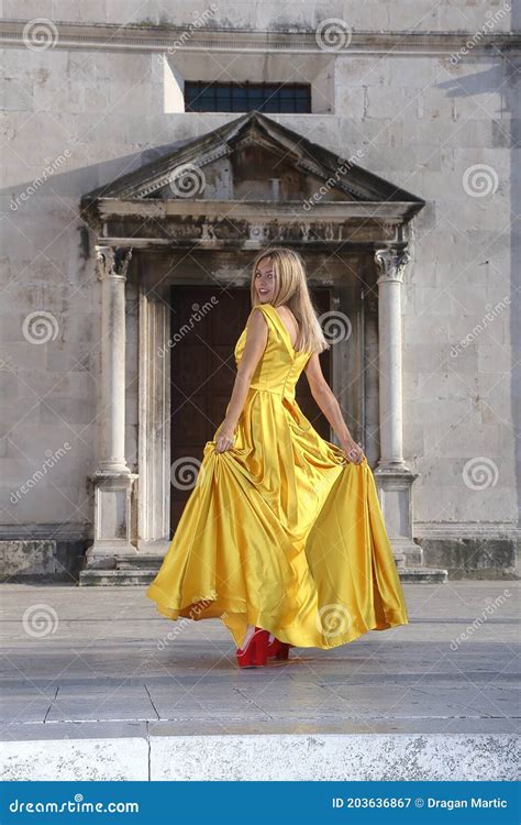 women in yellow dresses in the square stock image image of beauty hair 203636867
