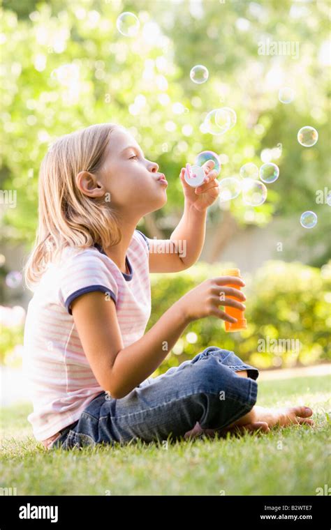 Young Girl Blowing Bubbles Outdoors Stock Photo Alamy