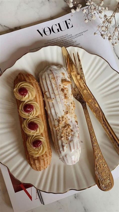 Two Pastries Sitting On Top Of A Paper Plate Next To Silverware And Forks