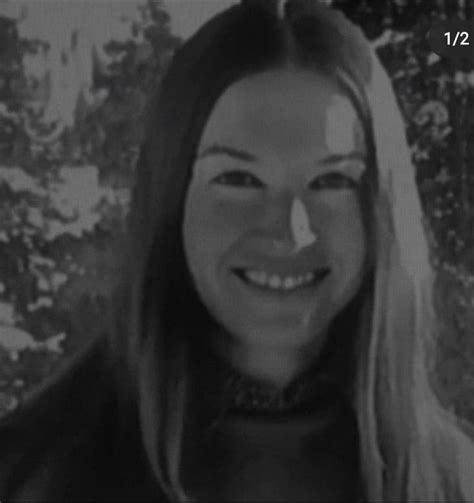 A Black And White Photo Of A Woman With Long Blonde Hair Smiling At The