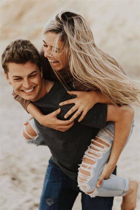Two People Hugging Each Other On The Beach