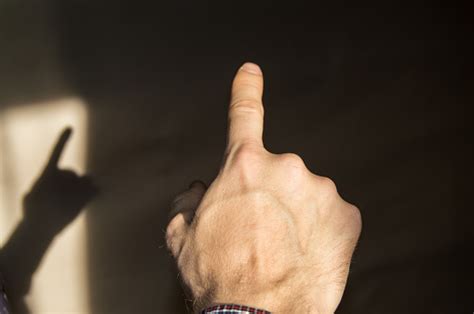 Index Finger Raised Up Man Shows Gesture Of Attention Touch Point Back