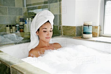 Mixed Race Woman Having Bubble Bath Stock Photo Dissolve