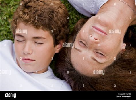 Woman With Her Grandson Napping In A Garden Stock Photo Alamy