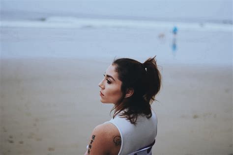 tattooed woman at the sand beach looking in the distance friends and rad playlists 4k hd wallpaper