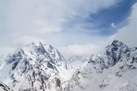 High Mountain Peaks Covered With Snow And Beautiful Blue Sky With