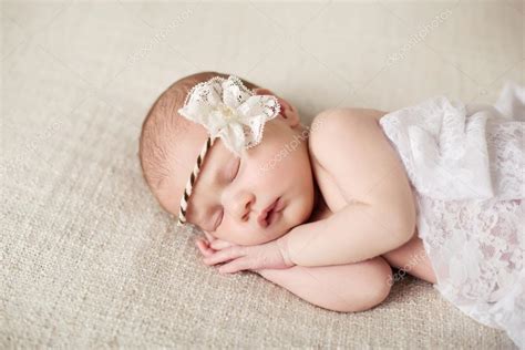 Newborn Baby Girl Sleeping On A Blanket — Stock Photo © Natkin 74059657
