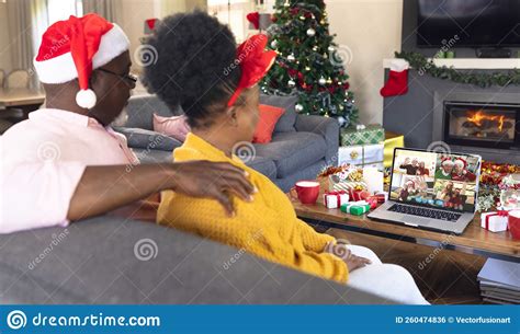 Senior African American Couple Having Christmas Video Call With Diverse