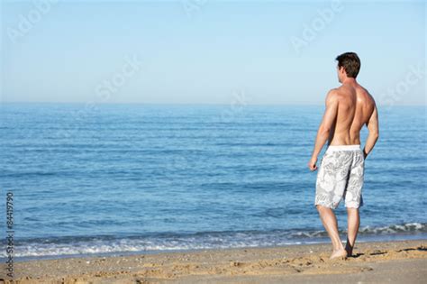Young Man Standing On Summer Beach Stock Photo And Royalty Free