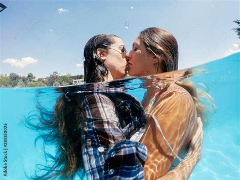Two Lesbian Women Having Fun In Swimming Pool One Summer Afternoon