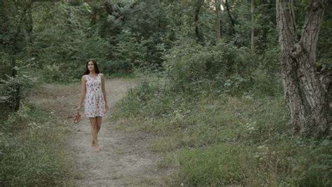 Beautiful Woman Barefoot In The Dress Walking Along A Path In The Woods
