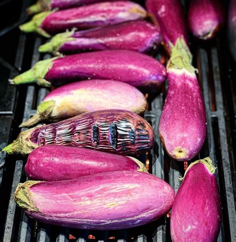 Purple Eggplant Sitting On Top Of A Grill