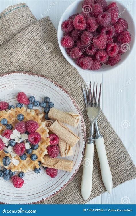 Waffles With Fresh Banana Raspberries Blueberries For Breakfast