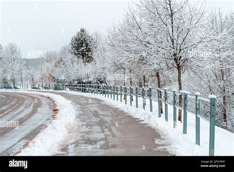 Wet Snow And Mud Covered Asphalt Road And Sidewalk Stock Photo Alamy