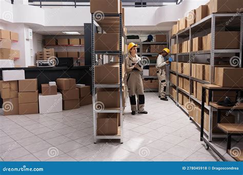Warehouse Operatives Managing Goods Receiving Inventory In Stockroom
