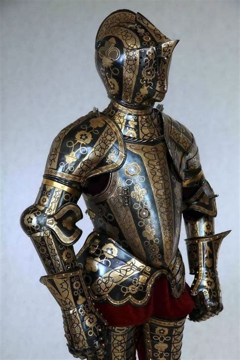 A Knight In Armor Standing With His Hands On His Hips