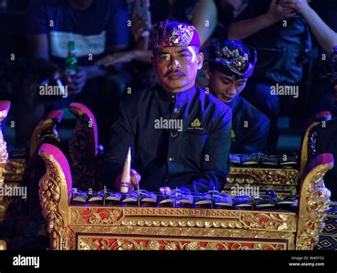 Member Of The Gamelan Playing Balinese Xylophone To Accompany