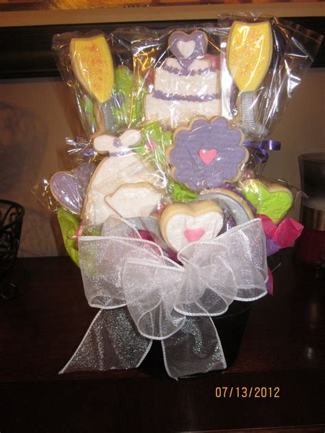 Wedding cookie arrangements are a wonderful way to congratulate newlyweds on their vows. Wedding Cookie Bouquet! | Wedding cookies, Wedding ...