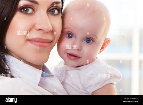 Happy Smiling Mother With Six Month Old Baby Girl Stock Photo Alamy