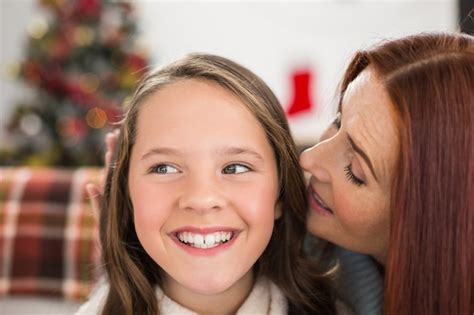 Premium Photo Mother Telling Her Daughter A Christmas Secret
