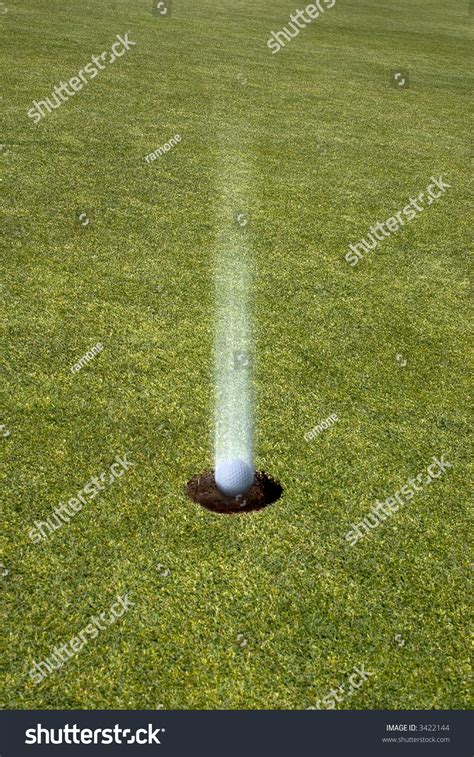 Golf Ball Landing Straight In The Hole On A Golf Green Hole In One