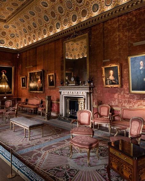 An Ornate Room With Chairs And Paintings On The Walls Along With A
