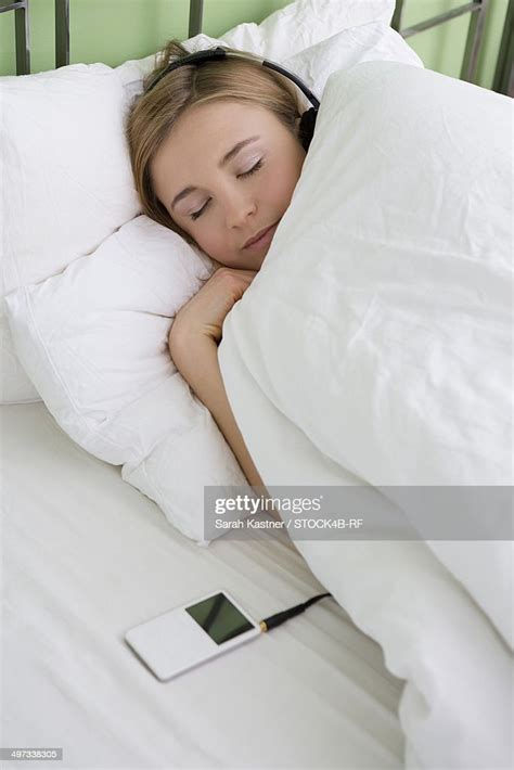 Young Woman Listening To Music In Bed High Res Stock Photo Getty Images